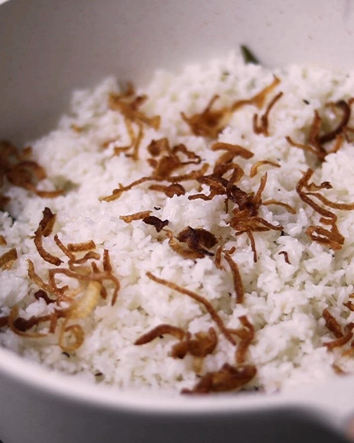 White rice topped with deep-brown fried onions